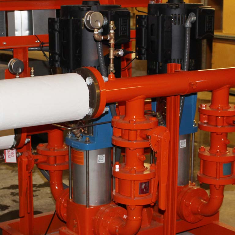 Close-up of red pipes within a building