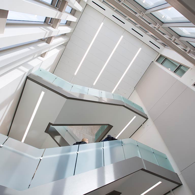 Students walk up a staircase in the School of Public and Environmental Affairs Building.